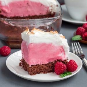Piece of baked Alaska with chocolate sponge cake, raspberry ice